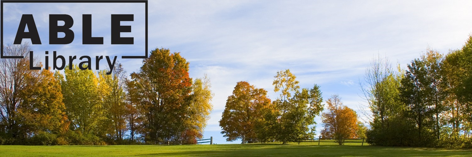 Landscape of trees in autumn with leaves turning orange, red, and yellow. Blue sky and white clouds behind the trees with the ABLE Library logo.