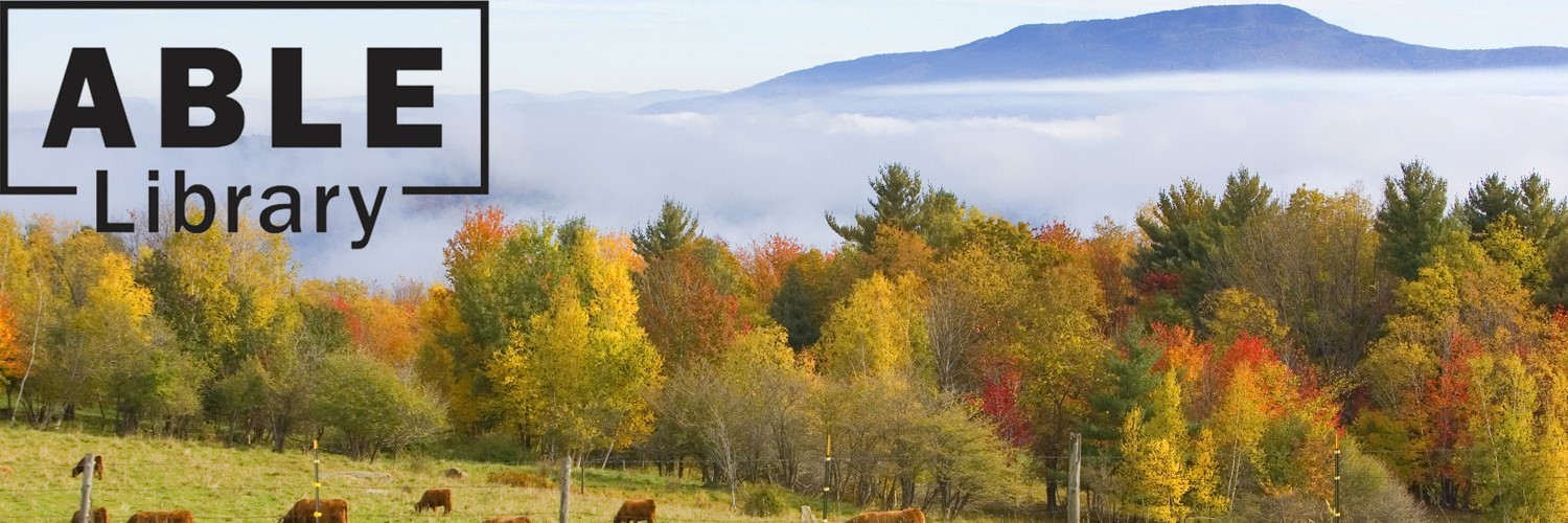 Landscape of trees in autumn with leaves turning red, orange, and yellow. Cows grazing in front of the trees, and blue sky, clouds, and mountains behind the trees with the ABLE Library logo.